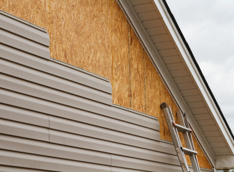 beige brown siding of a house with grey roofing