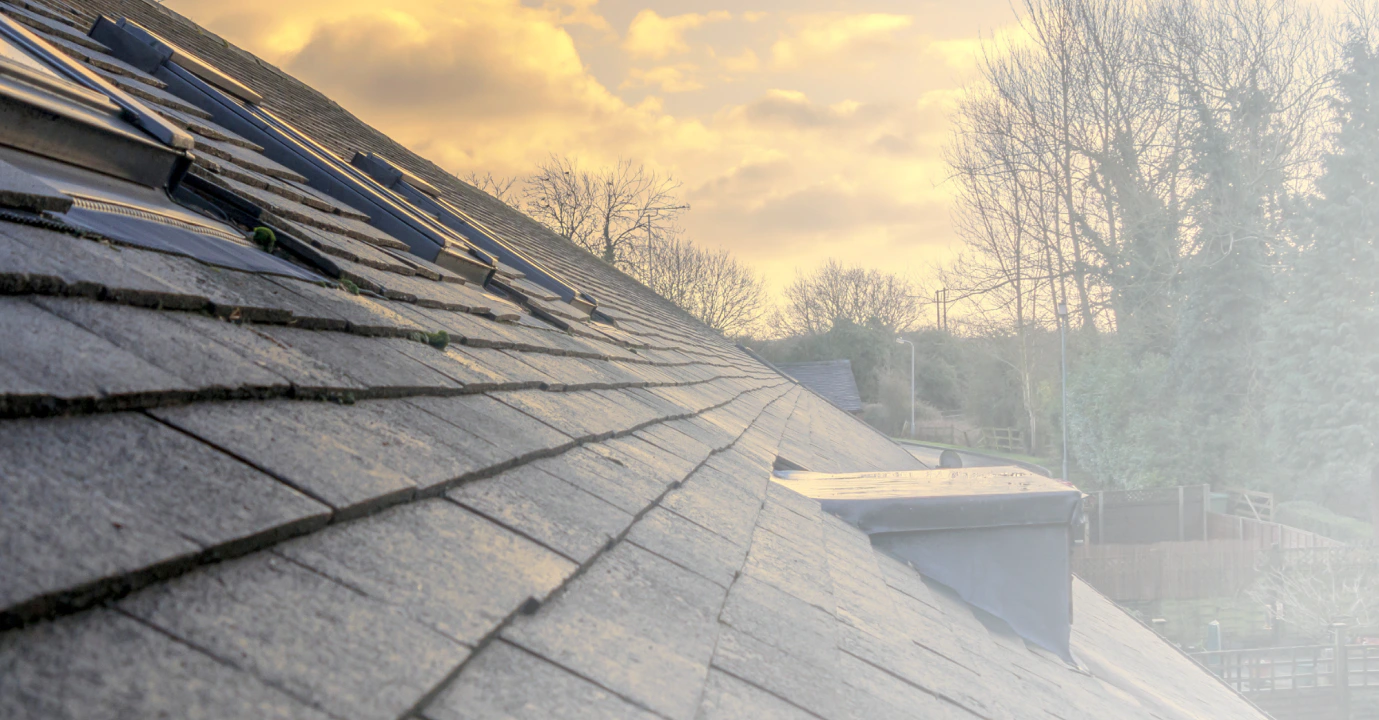 grey roofing of a house with some windows